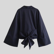 Women's top with elegant wrap detail in white or black