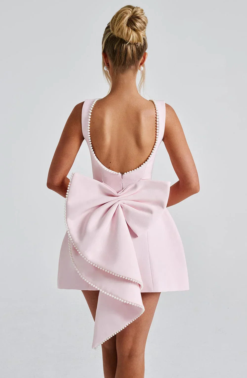 Dames cocktailjurk met strik detail en pareltjes - Avondjurk