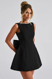 Dames cocktailjurk met strik detail en pareltjes - Avondjurk