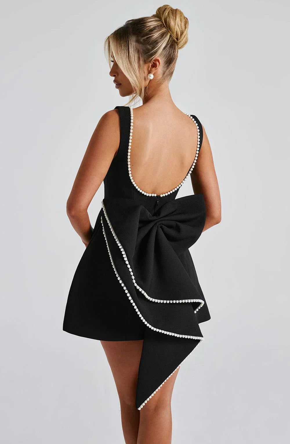 Dames cocktailjurk met strik detail en pareltjes - Avondjurk