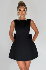 Dames cocktailjurk met strik detail en pareltjes - Avondjurk