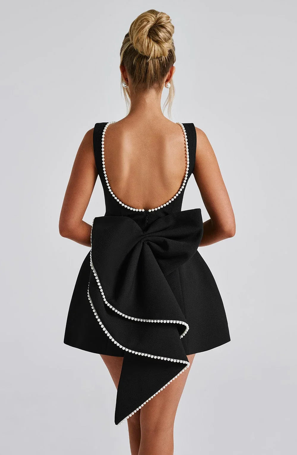 Dames cocktailjurk met strik detail en pareltjes - Avondjurk