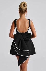 Dames cocktailjurk met strik detail en pareltjes - Avondjurk
