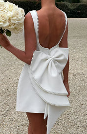 Dames cocktailjurk met strik detail en pareltjes - Avondjurk