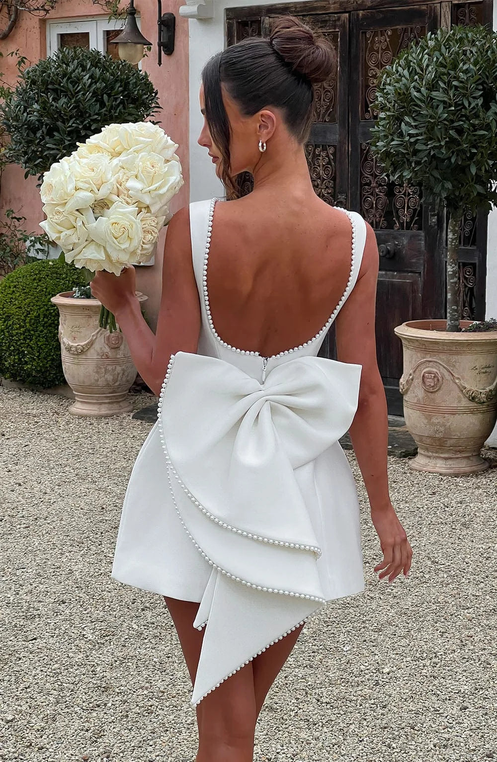 Dames cocktailjurk met strik detail en pareltjes - Avondjurk